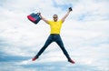 Active man jumping with travel bag midair sky background, vacation Royalty Free Stock Photo