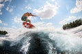 Active man jumping on the waves of the river Royalty Free Stock Photo