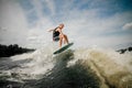 Active man jumping on the waves of the river Royalty Free Stock Photo