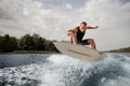 Active man jumping on the white wakeboard down the blue water ag Royalty Free Stock Photo