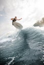 Active man jumping on the white wakeboard on the wave Royalty Free Stock Photo