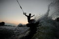 Active man riding on a wake board at the evening