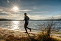 Active Man running at lake. Travel adventure healthy lifestyle concept vacations, athletic person