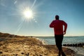 Active Man is running at lake. Travel adventure healthy lifestyle concept vacations, athletic person Royalty Free Stock Photo