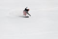 Active man snowboarder roundly descends from the mountain in freeride style