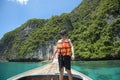 Active man on thai traditional longtail Boat is ready to snorkel and dive, Phi phi Islands, Thailand Royalty Free Stock Photo