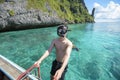 Active man on thai traditional longtail Boat is ready to snorkel and dive, Phi phi Islands, Thailand Royalty Free Stock Photo