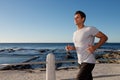 Active middle age man running outside by sea Royalty Free Stock Photo