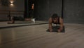 Determined muscular build African man standing in yoga plank position at gym