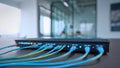 Active Network Switch: Glowing Indicator Lights and Ethernet Cables in a Modern Office Setup Royalty Free Stock Photo