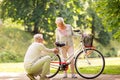 Happy senior couple with bicycle at summer park Royalty Free Stock Photo