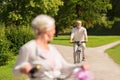 Happy senior couple riding bicycles at summer park Royalty Free Stock Photo