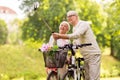 Senior couple with bicycles taking selfie at park Royalty Free Stock Photo