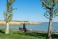 Active old fischerman with a bench at lake Balaton Royalty Free Stock Photo