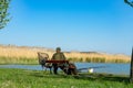 Active old fischerman with a bench at lake Balaton Royalty Free Stock Photo