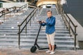 Active old woman riding electric scooter. Retired lady uses environmentally friendly city vehicle. Granny very old with Royalty Free Stock Photo