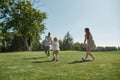 Active parents playing together with little boy child in green park on a summer day. Happy family enjoying leisure Royalty Free Stock Photo