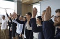 Joyful listeners of business conference raise their hands to ask questions to speaker or to vote. Royalty Free Stock Photo