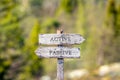 active passive text carved on wooden signpost outdoors in nature.