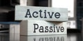 Active, passive - words on wooden blocks