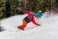 Snowboarder riding in the mountains on a sunny winter day Royalty Free Stock Photo