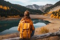 Backpacker woman with backpack enjoying the turquoise mountain lake. AI Generative