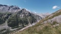 Active people walking up on the mountain trail. Clip. Group of hikers exploring breathtaking summer trail on rocks and Royalty Free Stock Photo