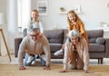 Active positive senior grandparents carrying excited little kids grandchildren on backs