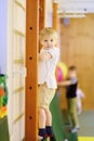 Active preschool boy during lesson in indoor sports hall/gym class