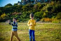 Active preschool girl and boy playing badminton in outdoor court in summer. Kids play tennis. School sports for children. Racquet