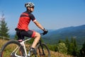 Active professional sportsman cyclist stopped bicycle on top of hill Royalty Free Stock Photo