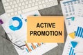 Active Promotion is written in a document on the office desk