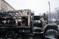 Active protester stands on the burned military aut