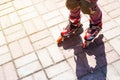 Active rest for children in the summer. Roller skating in the park Royalty Free Stock Photo