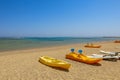 Active rest, sport, kayak. Boat for rafting on water. A few kayaks stand on beach. Beautiful tropical beach with palm trees,