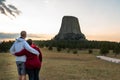 An active retired couple stand with backs to the camera looking at Devils Tower in Wyoming. Looking to the future concept for Royalty Free Stock Photo
