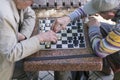 Active retired people, old friends and free time, two seniors having fun and playing chess game at park. Old men are playing chess Royalty Free Stock Photo