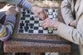 Active retired people, old friends and free time, two seniors having fun and playing chess game at park. Old men are playing chess Royalty Free Stock Photo