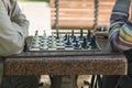 Active retired people, old friends and free time, two seniors having fun and playing chess game at park. Old men are playing chess Royalty Free Stock Photo