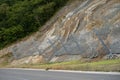 Active robust rockfall barrier system with wire mesh along the road, brake for rocks fall.