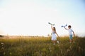 Active running kids with boy holding airplane toy. Royalty Free Stock Photo