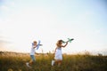 Active running kids with boy holding airplane toy. Royalty Free Stock Photo