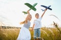 Active running kids with boy holding airplane toy. Royalty Free Stock Photo