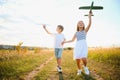 Active running kids with boy holding airplane toy. Royalty Free Stock Photo