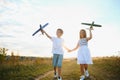Active running kids with boy holding airplane toy. Royalty Free Stock Photo