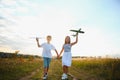 Active running kids with boy holding airplane toy. Royalty Free Stock Photo