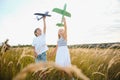 Active running kids with boy holding airplane toy. Royalty Free Stock Photo