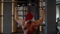 Active santa man doing bench press at gym. Sportsman training in sport club Royalty Free Stock Photo