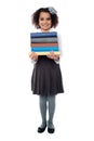 Active school child carrying stack of books Royalty Free Stock Photo