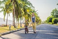 Active school kid boy and his mom in safety helmet riding a bike with backpack on sunny day. Happy child biking on way Royalty Free Stock Photo